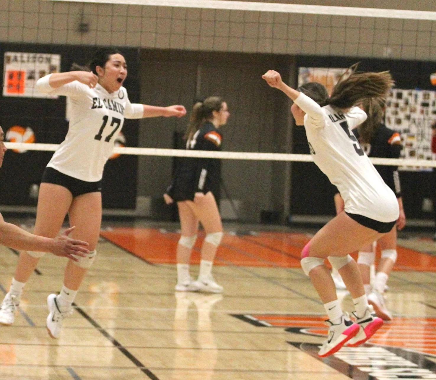 El Camino’s Penelope Madayag (l) and Italia Ghilarducci celebrate the Colts’ five-set win over Woodside to pull even with the Wildcats atop the PAL Ocean Division standings